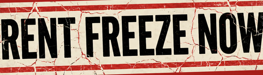 Wide red sticker with a cracked, distressed red border around a cream panel; black block lettering reads RENT FREEZE NOW.